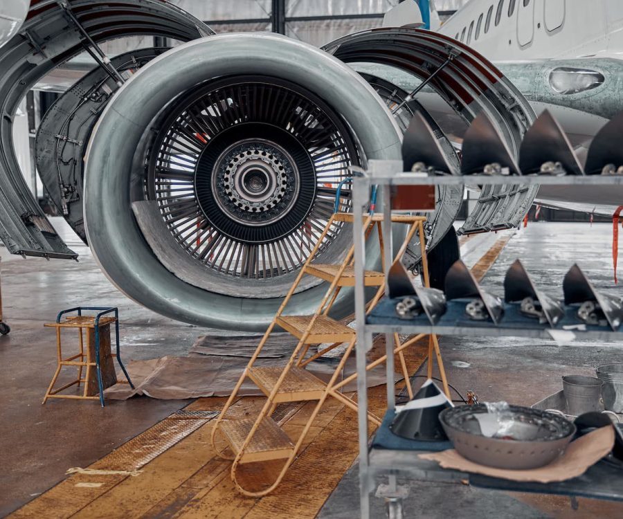 An aircraft engine undergoing maintenance, highlighting the use of precision tools in aerospace manufacturing.