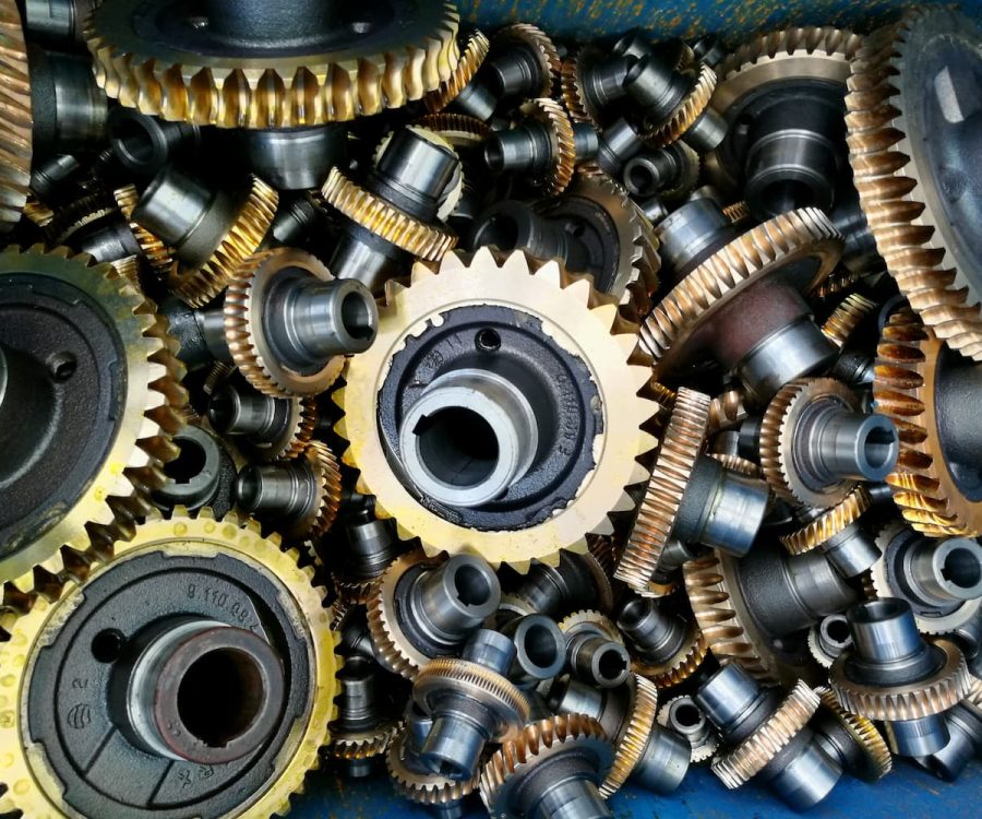 A collection of industrial gears and mechanical components machined with precision tools.